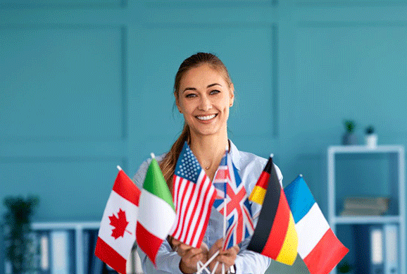 A tutor holding flags of different countries